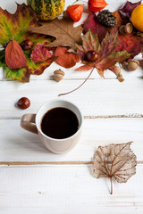 Cup of coffee and autumn leaves.