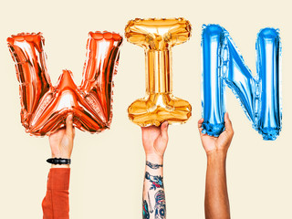 Hands showing win balloons word