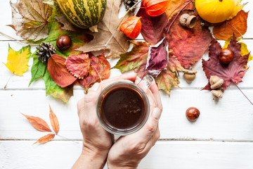 Cup of coffee and autumn leaves.