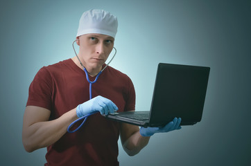 Computer technician engineer in the medical gloves and with stethoscope is repairing a laptop computer.