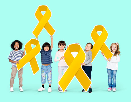 Kids holding gold ribbons supporting childhood cancer awareness