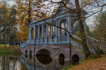 Marble bridge in autumn foliage in Catherine park (Pushkin), St. Petersburg, Russia