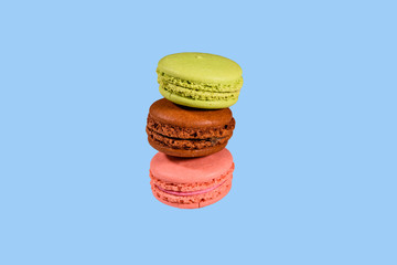 Stack of the french macaroons isolated on a blue background