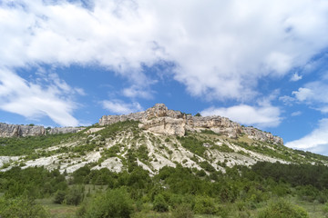 Fototapeta premium Low mountains surrounded by green bushes