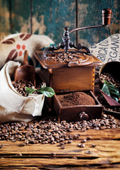 Retro wooden coffee mill with roasted beans