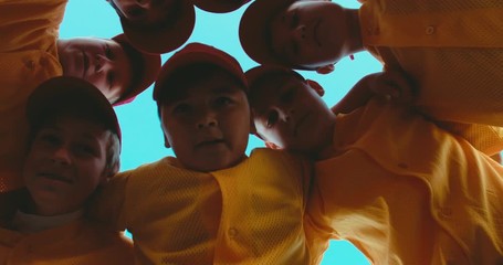 LOW ANGLE kid boys huddling up before game, captain inspires his team. 4K UHD 60 FPS SLO MO - Powered by Adobe