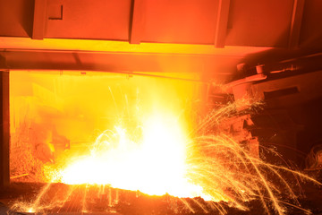iron works blast furnace taphole spewing molten iron