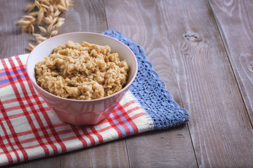 Oatmeal in a plate. Napkin. Nuts Berries. Honey