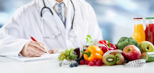 Dietitian writing a prescription for healthy diet