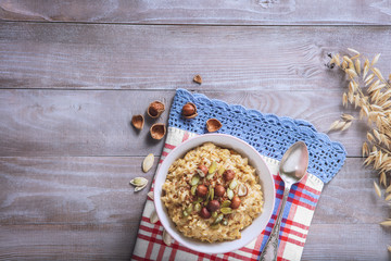 Oatmeal in a plate. Napkin. Nuts Berries. Honey