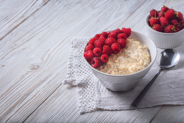 Oatmeal in a plate. Napkin. Nuts Berries. Honey