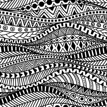 Wavy seamless ethnic pattern. Black and white print for textiles hand-drawn in the style of doodle. Aztec and tribal motifs. Vector illustration.