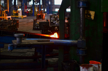 Fototapeta premium High precision hot forging product, automotive part production by hot forging process, automatice line hot forging. Iron melting recycling work. Heavy industry metallurgical plant sparks stove metall