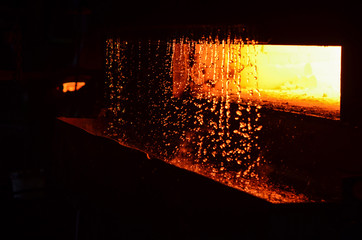 High temperature in the melting furnace. Metallurgical industry. Steelmaking plant and steelmaking workshop. Heavy forging Plant.Oven. Water curtain. For abstract background and texture.