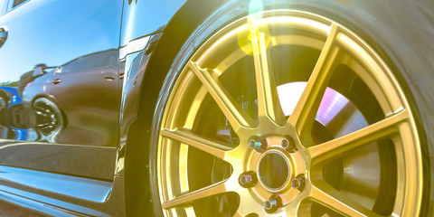 Tire rim with golden spokes of a reflective car