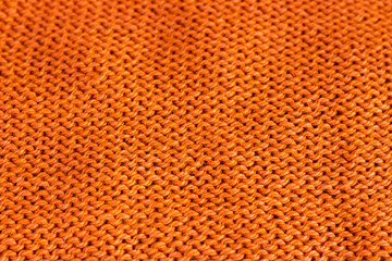 trend russet orange woolen knitted background, texture, close-up