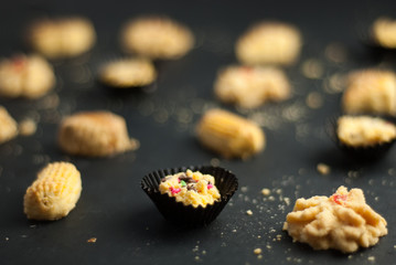 Cookies or biskut raya on black background. Special food for Eid festival or Hari raya