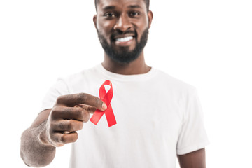 close-up shot of african american man in blank white t-shirt with aids awareness red ribbon looking...