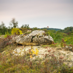 Landscape with boulder and chapel in the distance