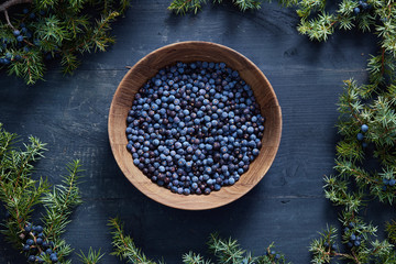 Wooden bowl with seeds of juniper.