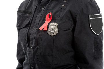cropped shot of female police officer with aids awareness red ribbon isolated on white