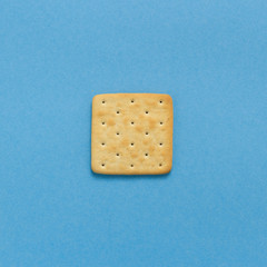 Tasty cookies biscuits on blue colored background, top view