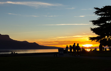 Fototapeta premium Sunset. Silhouette. People. Evening. Lake. Sky
