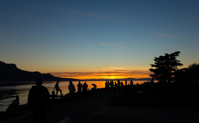 Fototapeta na wymiar Sunset. Silhouette. People. Sky. Evening. Lake