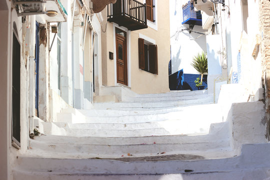 Fototapeta Stairs in the narrow street of Neorio town on Poros island, Greece  summer background