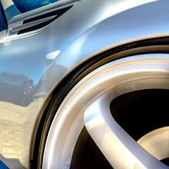 Wheel rim with white spokes on a shiny white car
