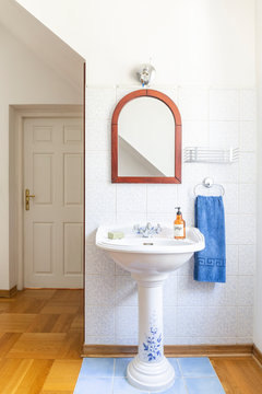 Old Fashioned Free Standing China Wash Basin With A Mirror Above In A Classic Bathroom Interior. Real Photo.