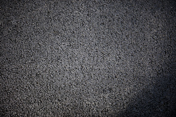 Black rough asphalt road texture background, Top view.