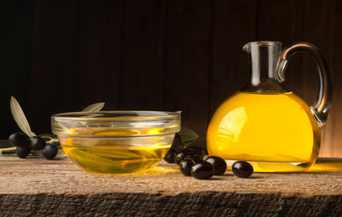 bottle with olive oil on the wooden table