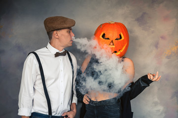Unusual couple at Halloween party, Woman with pumpkin on head