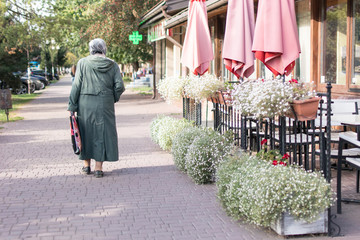 Grandmother pensioner walking down the street.