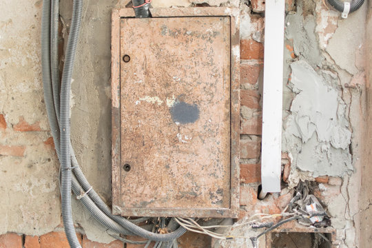 Old electric flap on the wall of the house.