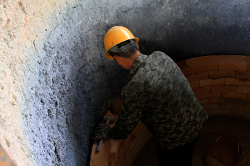 Workers are assembled steel crucible internal with refractory brick in a steel plant