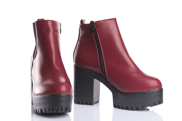 Pair of red platform boots with chunky heels for spring or autumn wear