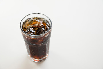 Cola with ice in glass top view