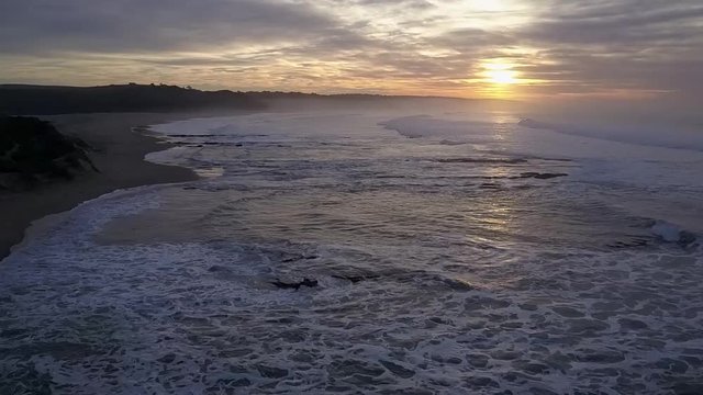 Aerial view of waves during sunset