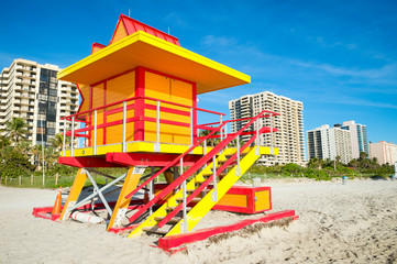 Fototapeta na wymiar Brightly coloured orange,red and yellow lifeguard tower on South Beach in Miami, Florida