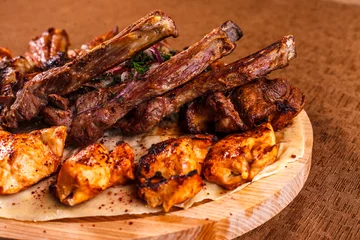 Keuken spatwand met foto Juicy barbeque pork ribs and dry chicken wings with glaze. Snacks for beer © antonkorobkov