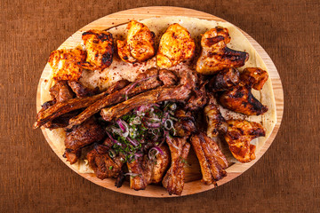 Juicy barbeque pork ribs and dry chicken wings with glaze. Snacks for beer
