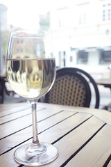 glass of white wine in the restaurant / white wine in the interior of the restaurant a table with glasses of wine, a romantic summer