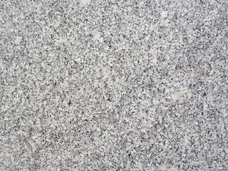 The texture of gray artificial stone interspersed with granite chips.
