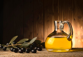 bottle with olive oil on the wooden table