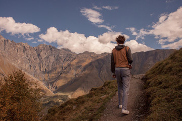 man is walking on the high mountain in Kazbegi, Georgia