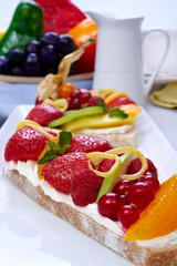Bread toast with orange, apple, strawberry, cheese, blueberry and raspberry