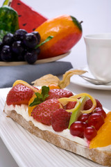 Bread toast with orange, apple, strawberry, cheese, blueberry and raspberry