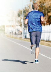 Male athlete, runner on the road